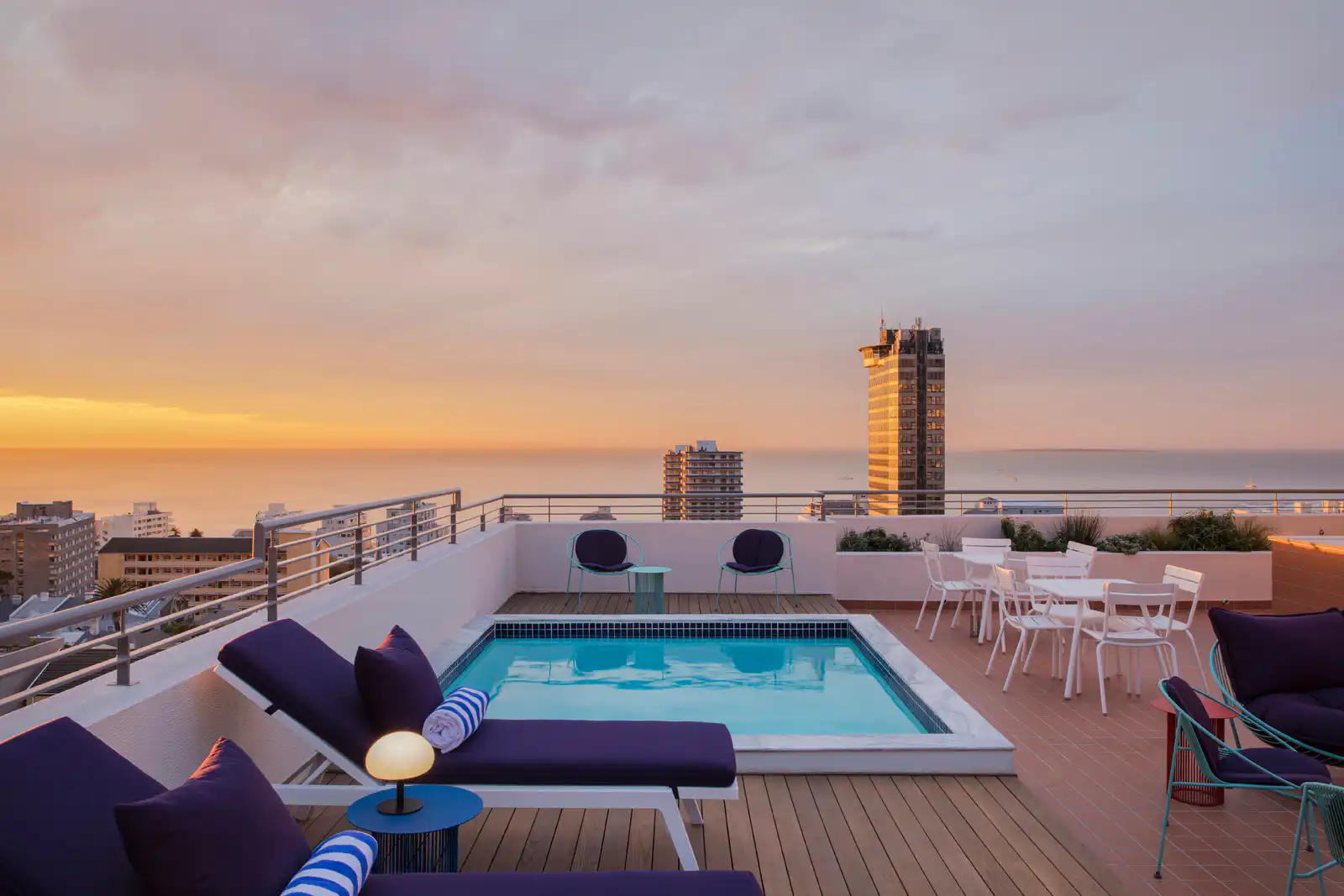 Rooftop pool at Home Suite Hotels Sea Point overlooking the Atlantic Ocean at sunset