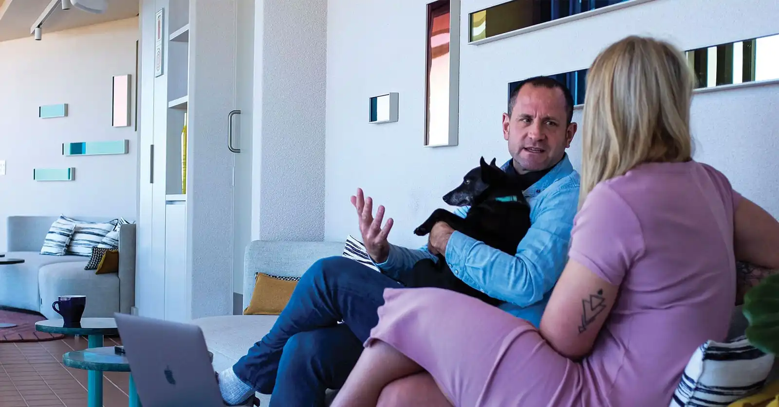 Guests relaxing with their dog at Home Suite Hotels