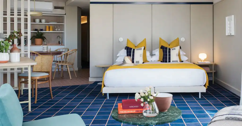 King-size bed and kitchenette in a Sea Point suite