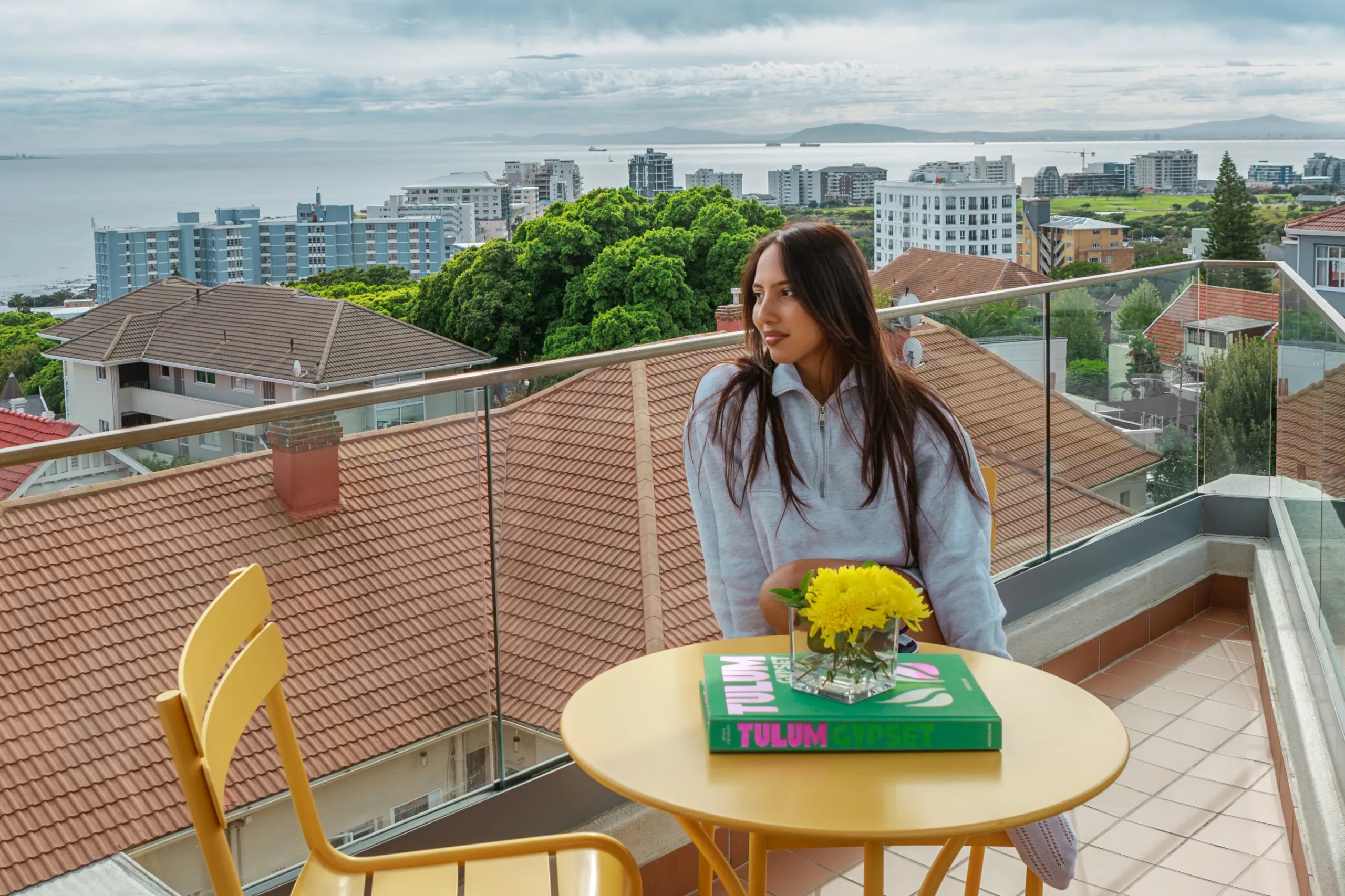 Guest on a sea-view balcony at Home Suite Hotels Sea Point in Cape Town