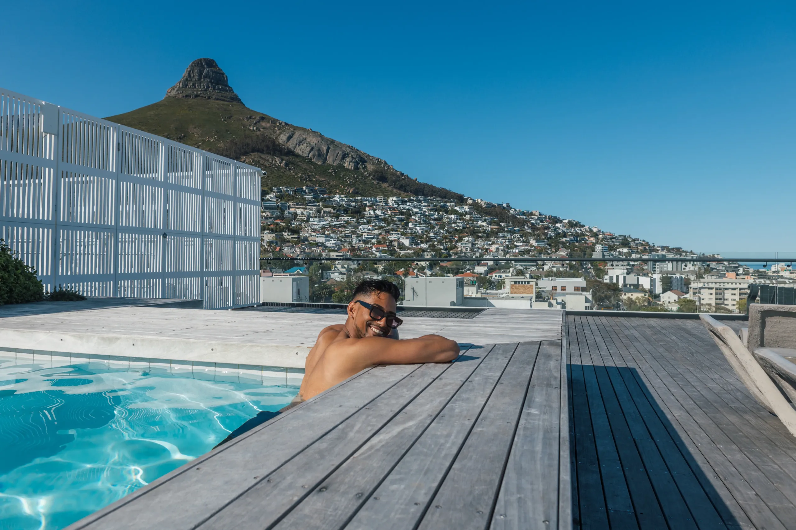 Guest relaxing in the rooftop pool at Station House with Lion's Head views