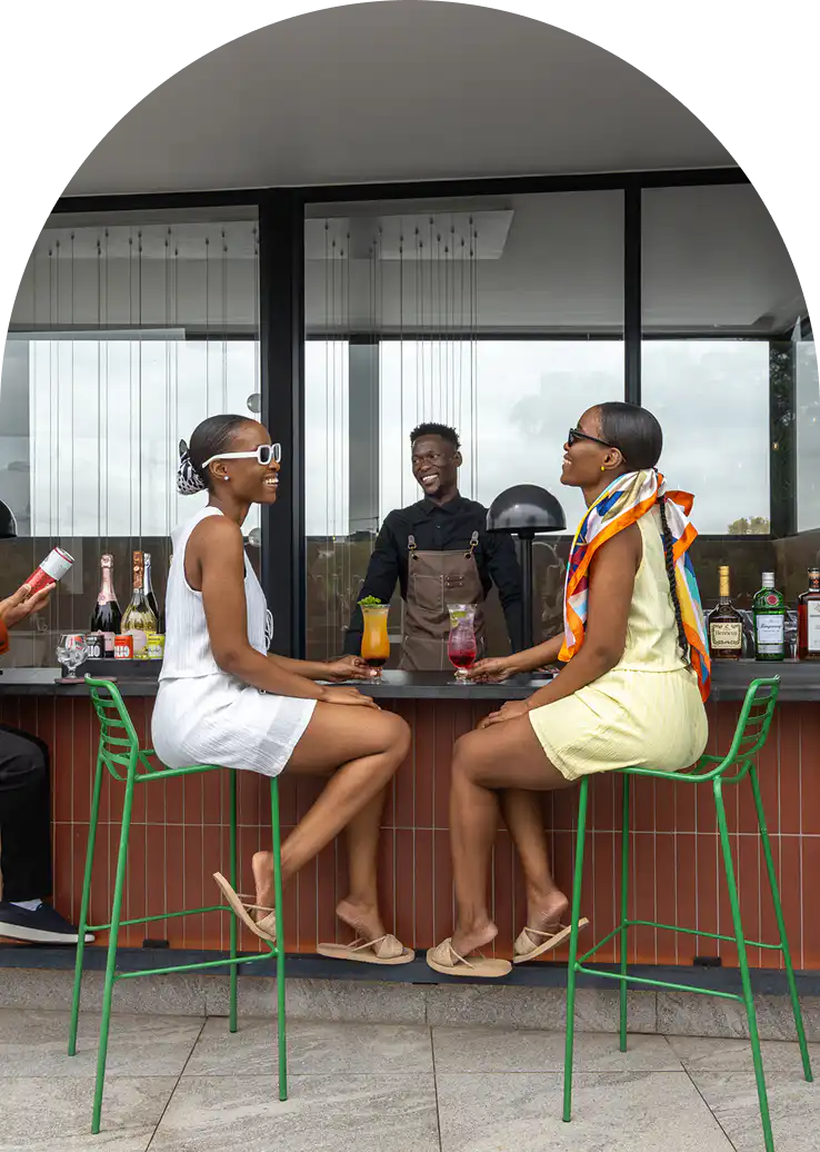 Guests enjoying cocktails at the rooftop bar at Home Suite Hotels Rosebank