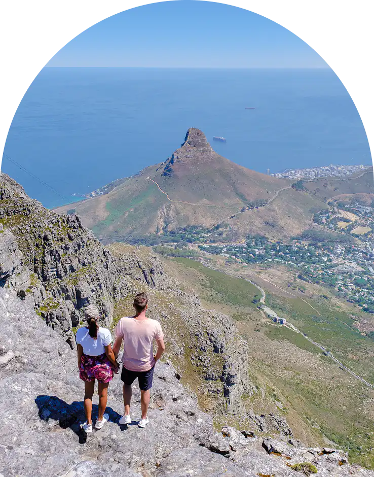 Couple overlooking Lion's Head and the Atlantic Ocean from Table Mountain