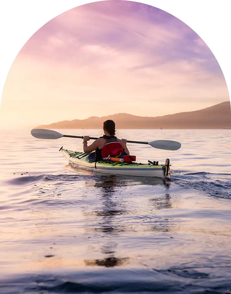 Guest kayaking off the Cape Town coast at sunset