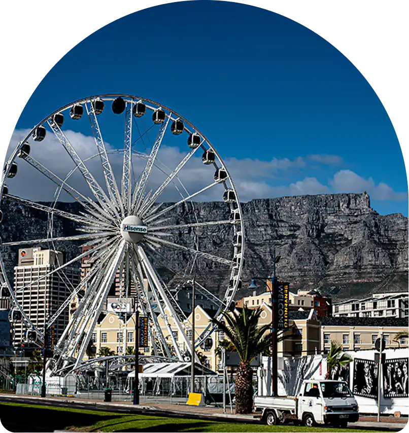 The Cape Wheel and Table Mountain at the V&A Waterfront, a Cape Town attraction near Home Suite Hotels Sea Point